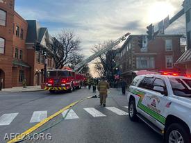 View of the 23 command truck and Ladder 25 laddering the building 