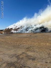 Crews arrived to find a large pile of straw well involved and spreading 